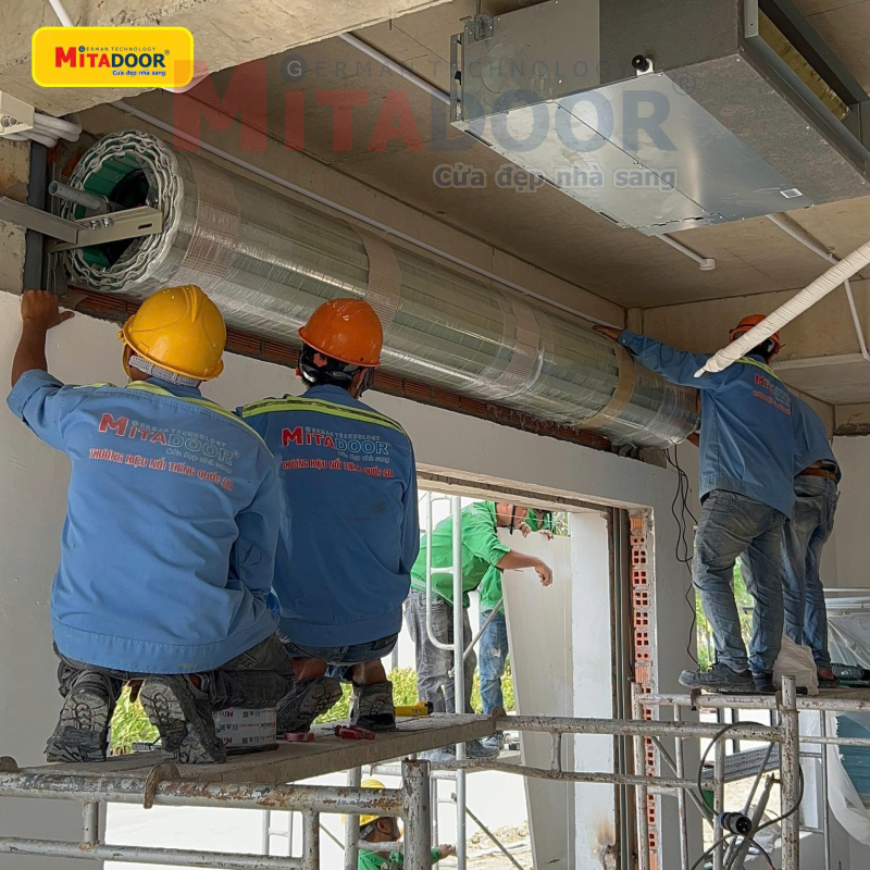 Nhân viên kỹ thuật của Mitadoor đang lắp đặt cửa cuốn Nhân viên kỹ thuật của Mitadoor đang lắp đặt cửa cuốn